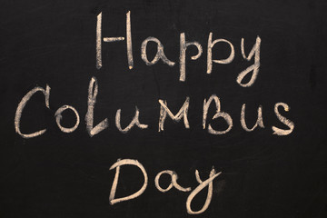 Fototapeta na wymiar Happy Columbus Day.Inscription in chalk on a black chalkboard