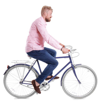 Young handsome man with bicycle on white background