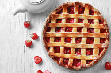 Delicious strawberry pie on table