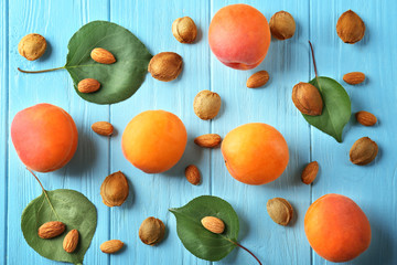 Composition with apricots and kernels on wooden background