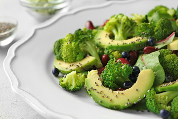 Superfood salad with avocado, beans and broccoli on white ceramic plate, closeup