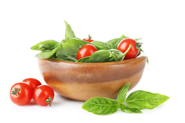 Cherry tomatoes and green fresh organic basil isolated on white