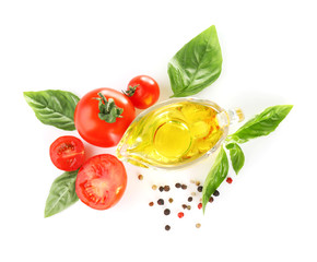 Cherry tomatoes, green fresh organic basil and gravy boat with oil isolated on white