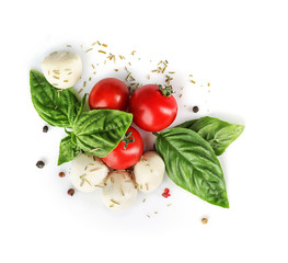 Mozzarella cheese balls, cherry tomatoes and green fresh organic basil isolated on white