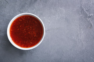 Chili sauce in bowl on table