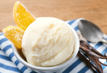 Bowl with delicious vanilla ice cream and marmalade on table, closeup