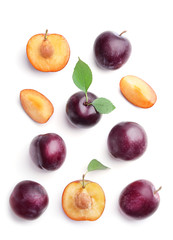 Fresh ripe plums on white background