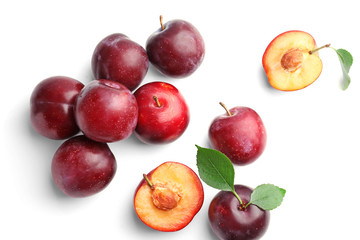 Fresh ripe plums on white background