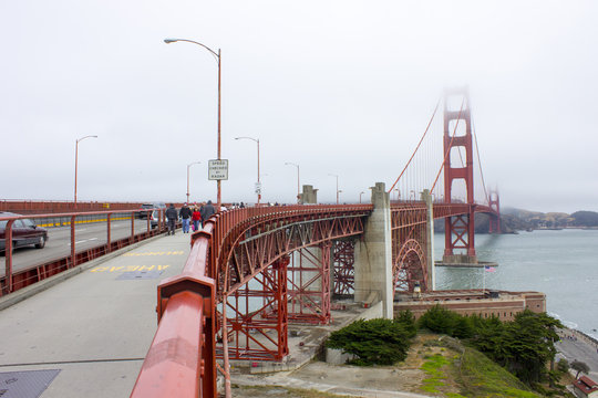 The Golden Gate Bridge, a painted red suspension bridge spanning the Golden Gate strait, the channel between San Francisco Bay and the Pacific Ocean