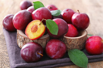 Fresh ripe plums on table, closeup