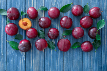 Fresh ripe plums on wooden table