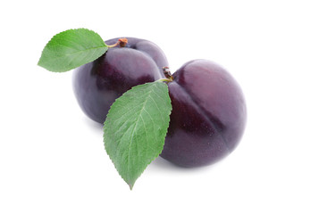 Fresh ripe plums on white background