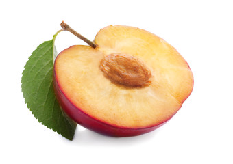 Half of fresh ripe plum on white background