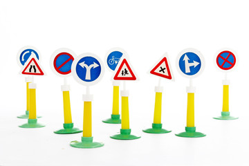 The Highway Code, road safety and vehicle rules driwing law road sign toys.   Learn road signs with toy  Traffic sign set for easy learning or illustrate every concept.Studio photo with white backgrou