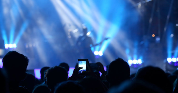 smartphones during the live concert of a rock band