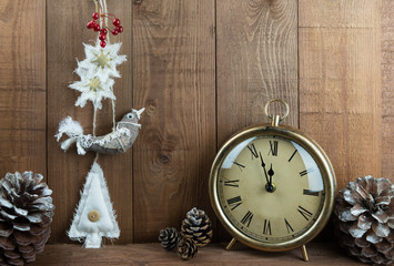 Folk art bird Christmas decorations, vintage clock and pinecones.