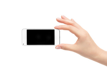 Woman's hand holds a white phone on a white background.