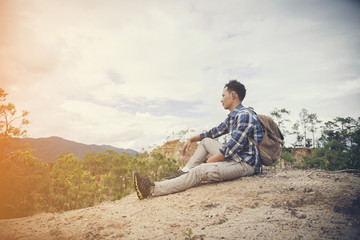 Naklejka na ściany i meble Young Man Traveler with backpack relaxing outdoor with rocky mountains on background Summer vacations and Lifestyle hiking concept