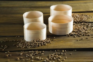 Plastic bowls and coriander seeds scattered 