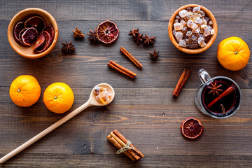 Hot mulled wine or grog cooking for new year celebration with oranges and spices ingredients on...