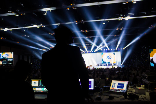 Silhouette of worker control, sound system and lighting in concert.