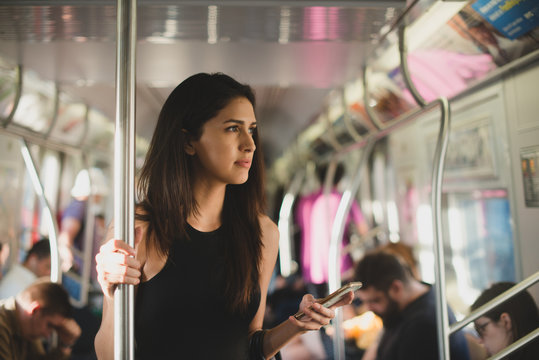 Young woman riding subway train in the city