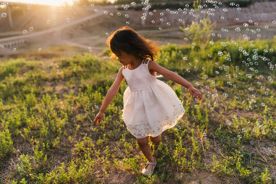 Cute little girl playing with bubble
