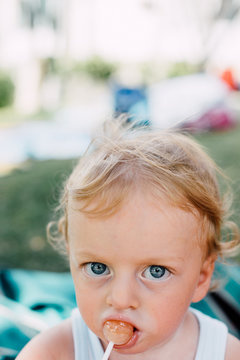 Little child eating chupa chups