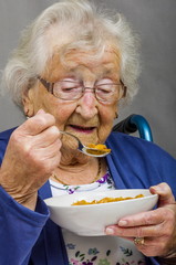 Senior Citizen eating.
Senior lady eating a bowl of cereals
