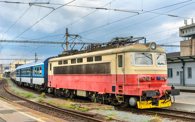 Fototapeta na wymiar Old electric locomotive with a passenger train at Brno station, Czech Republic