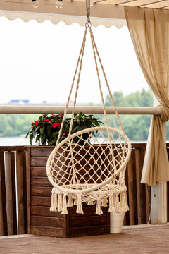 Round Swinging Chair In The Gazebo Outdoors. Summer