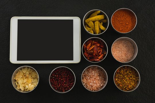 Various spices in bowl with digital tablet - Powered by Adobe