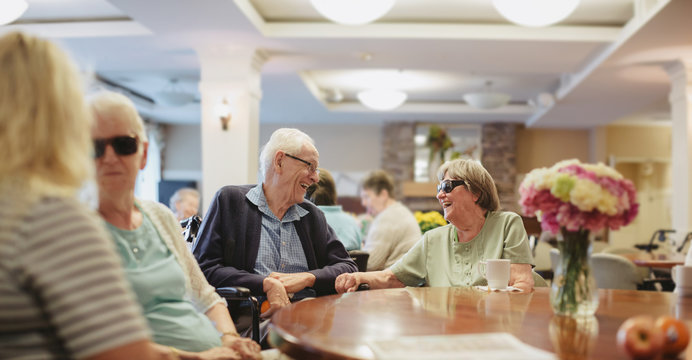 Group of senior folks hanging out around table
