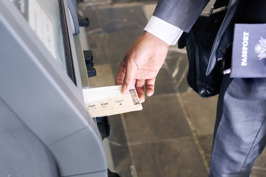 Business man getting boarding pass in check in machine