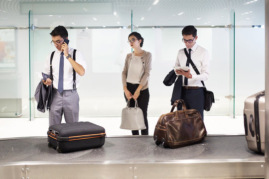 Young woman getting bored while waiting for her luggage