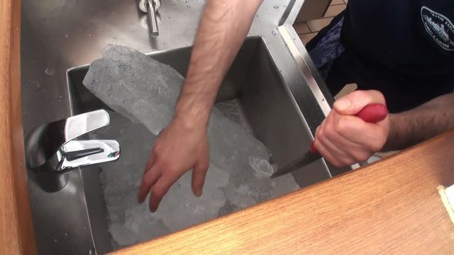 Hand Break Ice In Restaurant. Preparation Of Soda And Ice Cream.