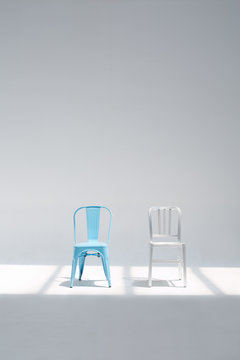 Two different chairs in the whtie studio