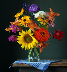 Bouquet of cultivated flowers in a glass vase.