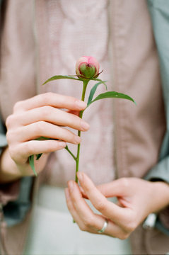 Woman holding peony's bud