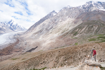 Landscape photographer shooting a glacier, working in Himalayas mountain, India