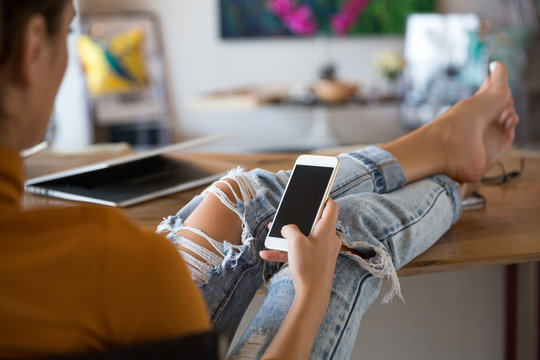 Woman checking her phone at home