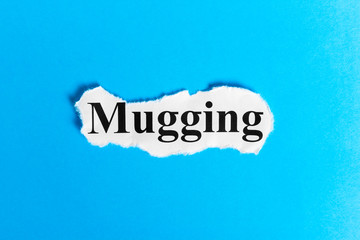 Mugging text on paper. Word Mugging on a piece of paper. Concept Image.