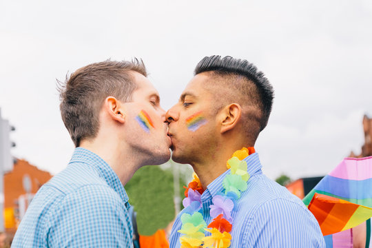 Side view of couple kissing during the pride parade