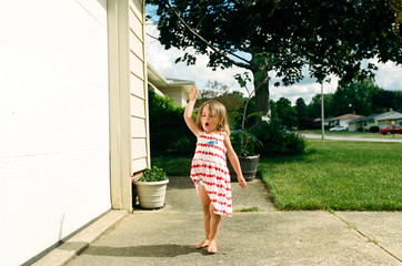 little girl dancing outside