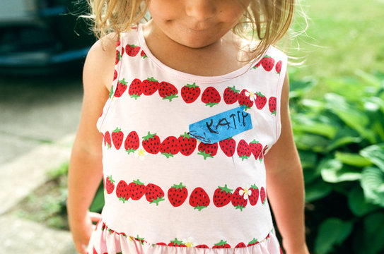 little girl with name tag in childs handwriting