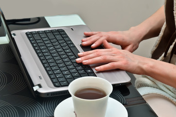 Woman working at home on notebook