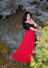 Fototapeta premium Beautiful witch in the forest. Halloween.