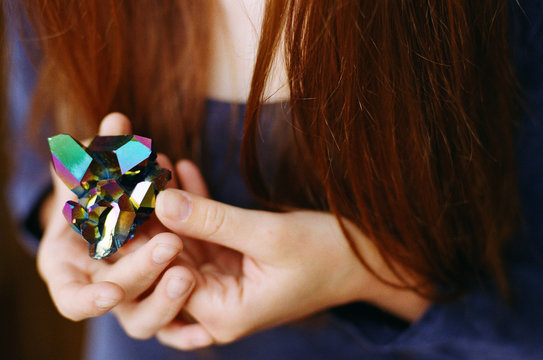Woman holding a mineral pyrite stone in her hands