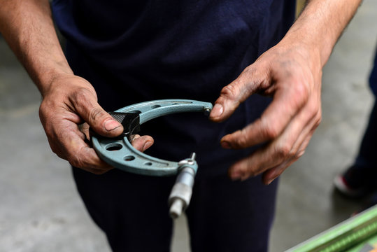 A mechanic holding a tool on a workshop