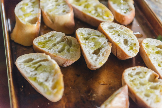 Preparing garlic bread for grill